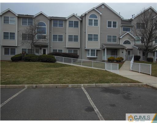 a front view of a residential apartment building with a yard