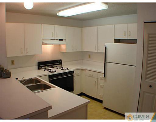 914 Edpas Road New Brunswick, NJ 08901 - Photo 3 of 11 a kitchen with a stove a refrigerator and a sink