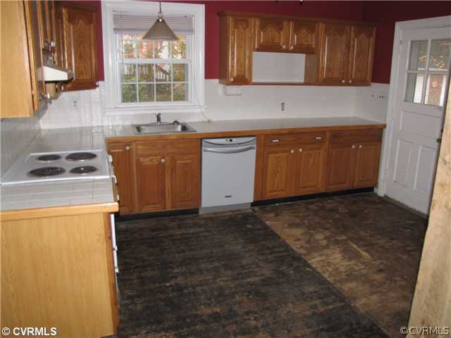 29521 Carson Road Carson, VA 23830 - Photo 2 of 12 a kitchen with a sink a stove and cabinets