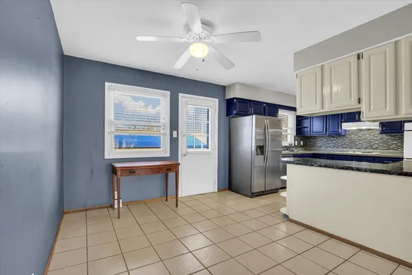 a kitchen with stainless steel appliances a refrigerator sink and microwave