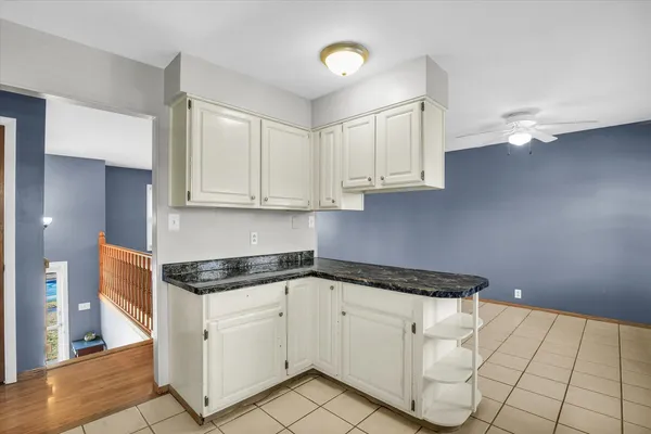a kitchen with white cabinets appliances and a sink