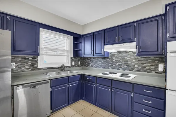 a kitchen with stainless steel appliances granite countertop wooden cabinets a sink and dishwasher