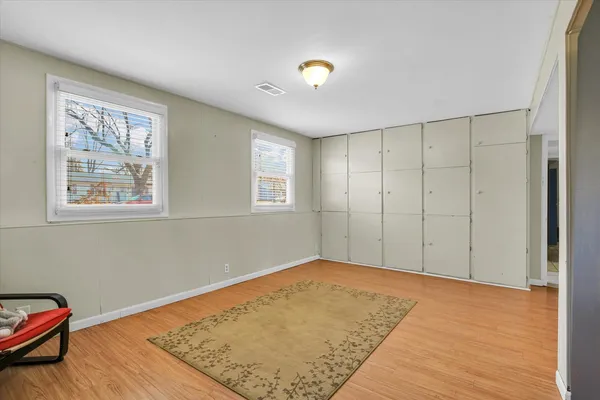 a view of a room with wooden floor and cabinet