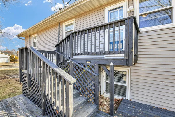 a roof deck view with table and chairs and wooden floor