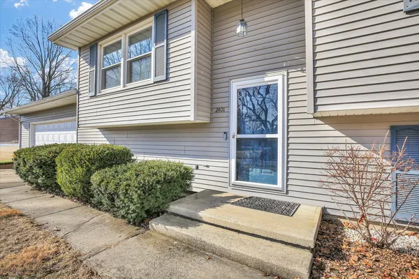a view of a house with a small chairs and a yard