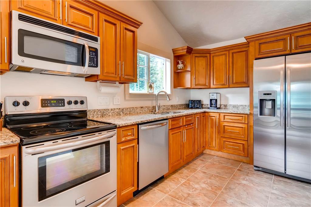 738 Deer Path Road Dillon, CO 80435 - Photo 7 of 25 a kitchen with stainless steel appliances granite countertop a stove microwave refrigerator and sink