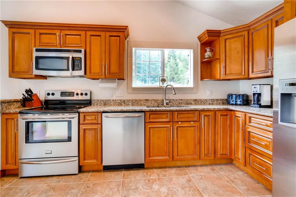 738 Deer Path Road Dillon, CO 80435 - Photo 9 of 25 a kitchen with granite countertop stainless steel appliances a stove sink and microwave