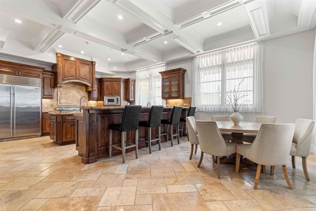 a kitchen with granite countertop a sink stove and cabinets