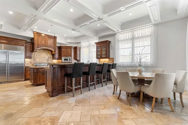 a kitchen with granite countertop a sink stove and cabinets