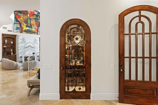 a living room with stainless steel appliances kitchen island granite countertop furniture and a chandelier
