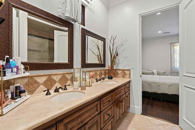 a bathroom with a granite countertop toilet a sink and a mirror