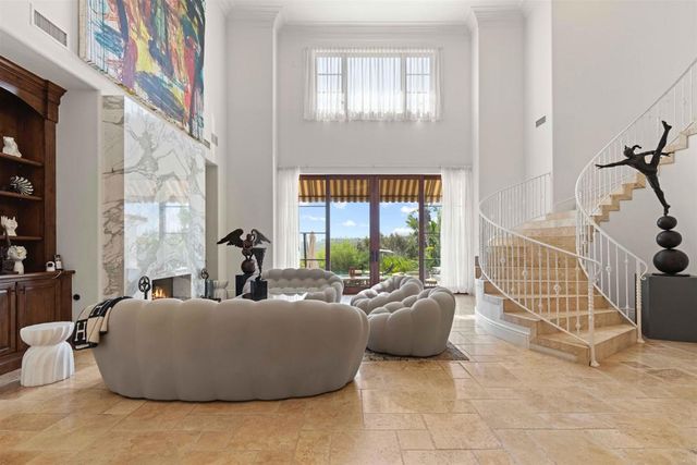 a living room with furniture and a floor to ceiling window