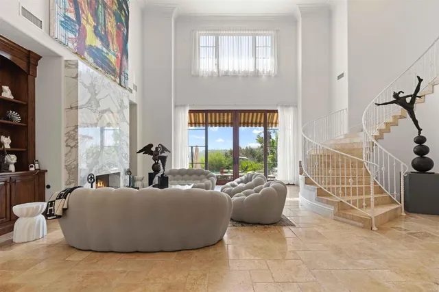 a living room with furniture and a floor to ceiling window