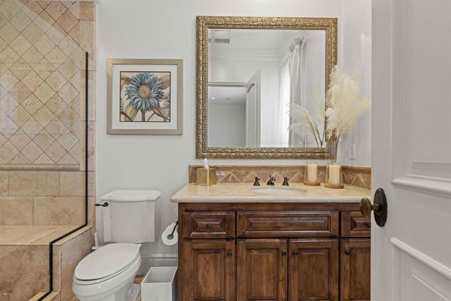 an aerial view of residential houses with outdoor space and trees