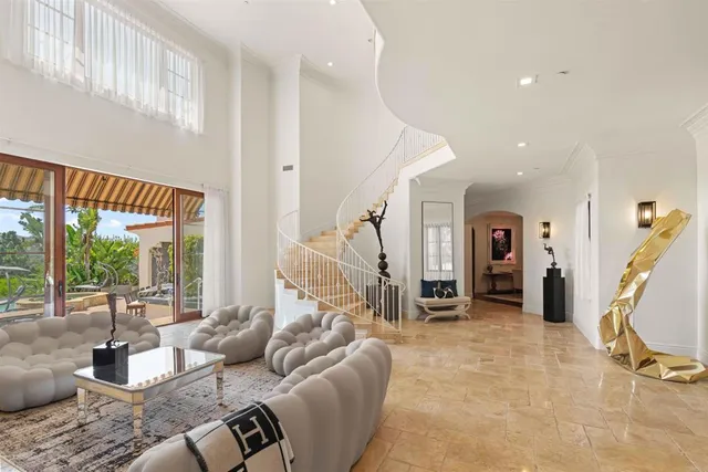 a living room with fireplace furniture and a floor to ceiling window