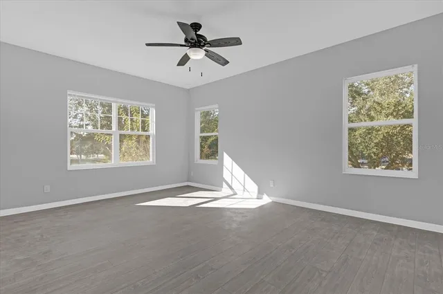 a view of a livingroom with a ceiling fan and window