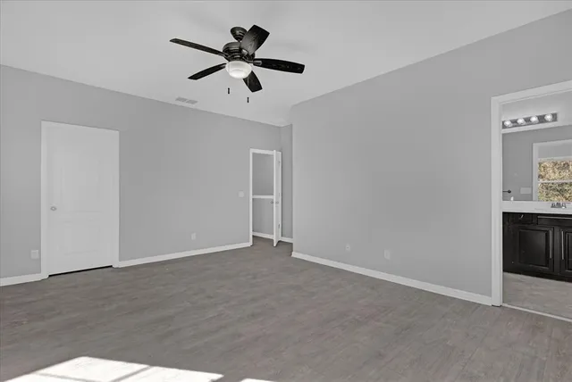 a view of room with ceiling fan and window