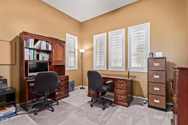 a view of a livingroom with workspace and a window