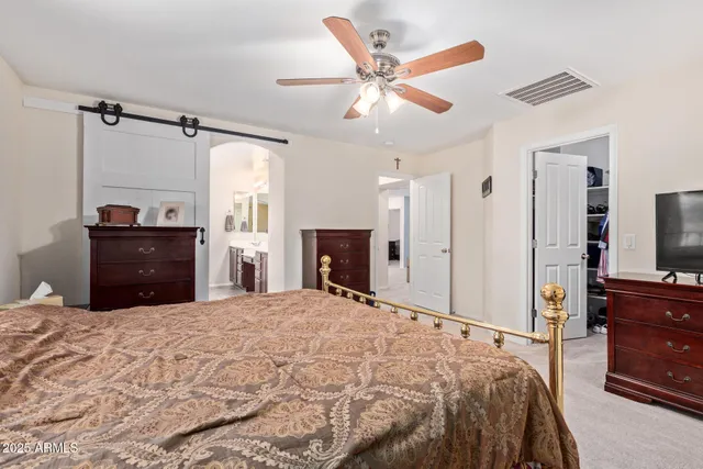 a bedroom with a bed and a chandelier