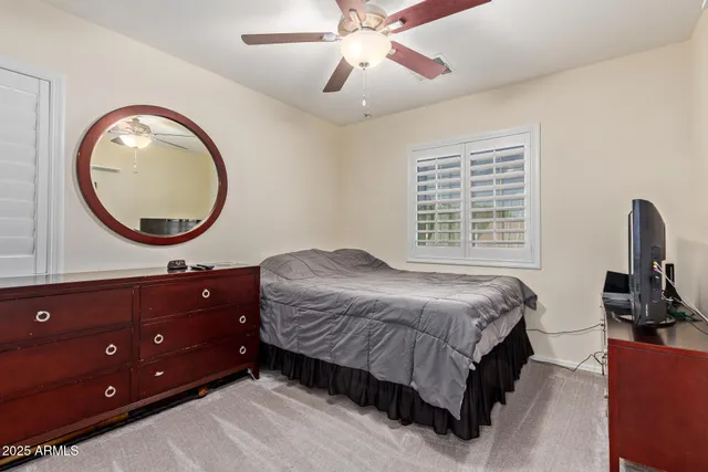 a bedroom with a bed and a dresser