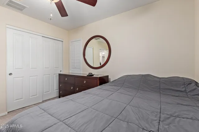 a bedroom with a bed and a dresser