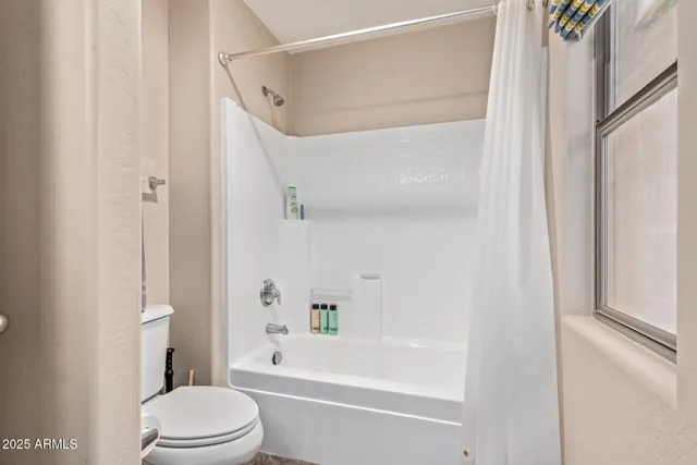 a bathroom with a bathtub and a toilet