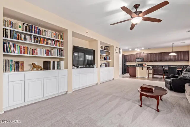 a living room with furniture and a bookshelf