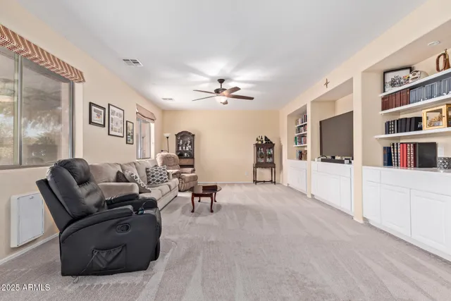 a living room with furniture and a book shelf