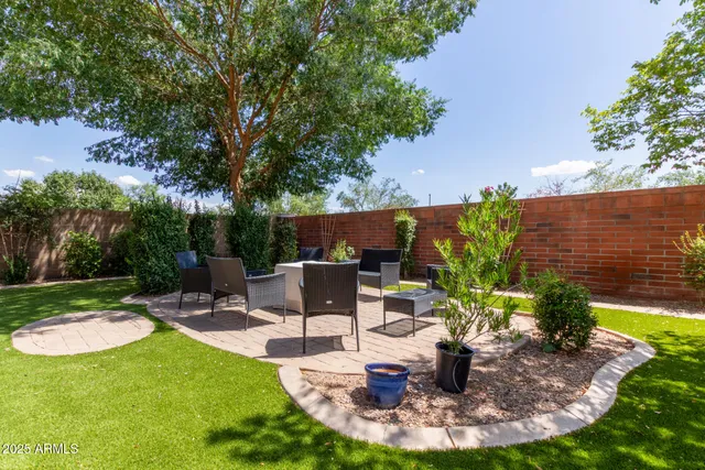 a view of a backyard with sitting area
