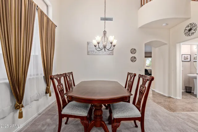 a view of a dining room with furniture and window