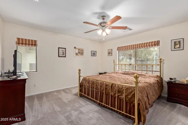 a bed sitting in a bedroom next to a window