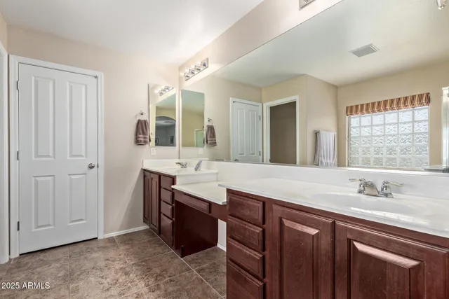 a bathroom with a granite countertop sink mirror and double