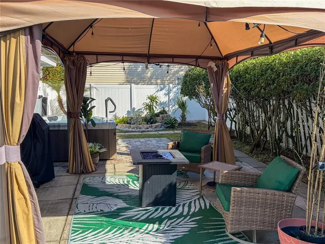 a patio with glass top table and chairs