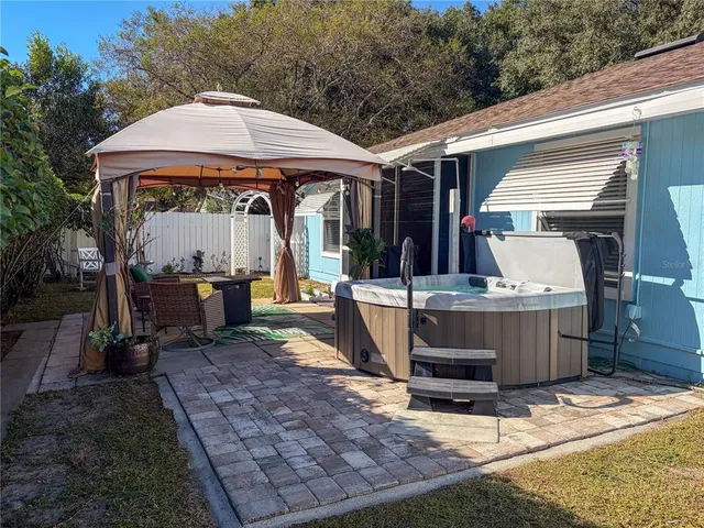 a view of a house with backyard porch and sitting area