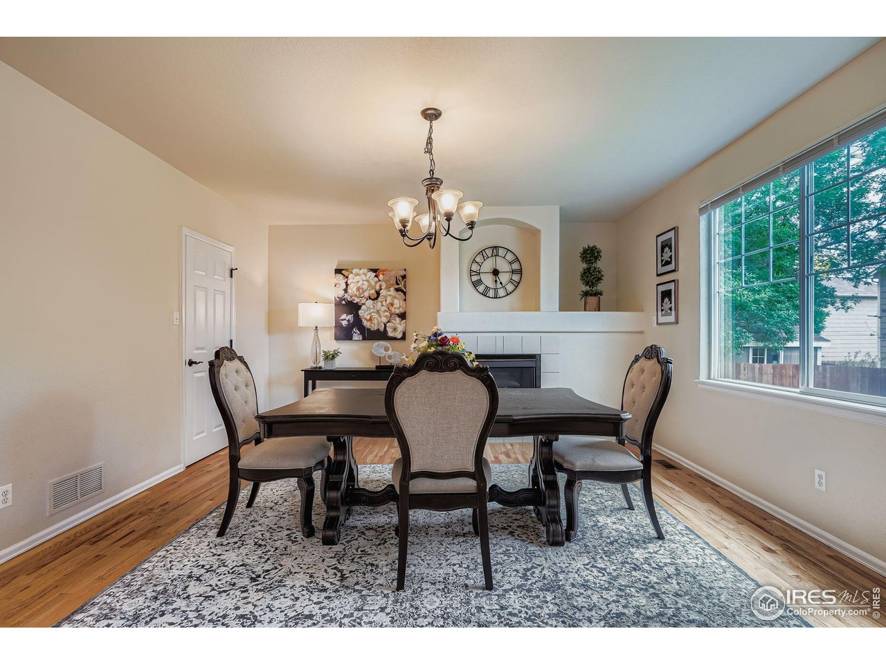 6178 Graden Street Frederick, CO 80530 - Photo 16 of 28 a dining room with furniture a rug and a large window