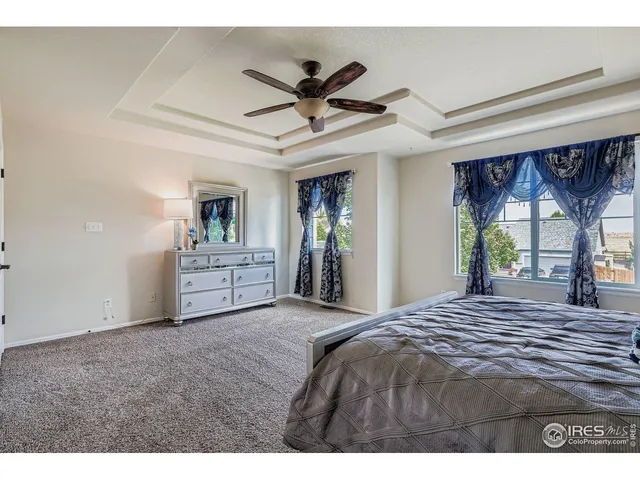 a view of a livingroom with a ceiling fan and window