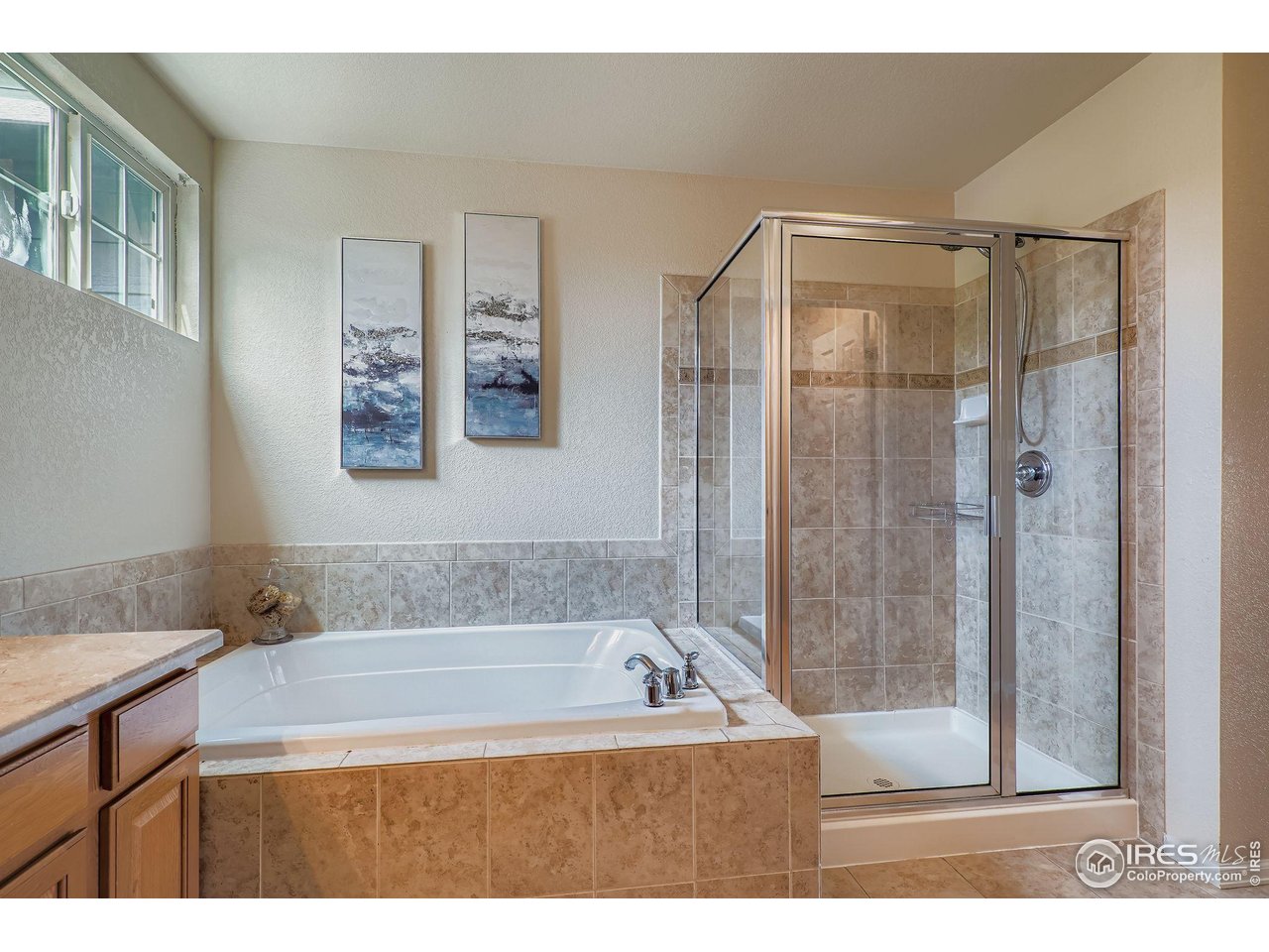 6178 Graden Street Frederick, CO 80530 - Photo 19 of 28 a bathroom with a bathtub and a shower