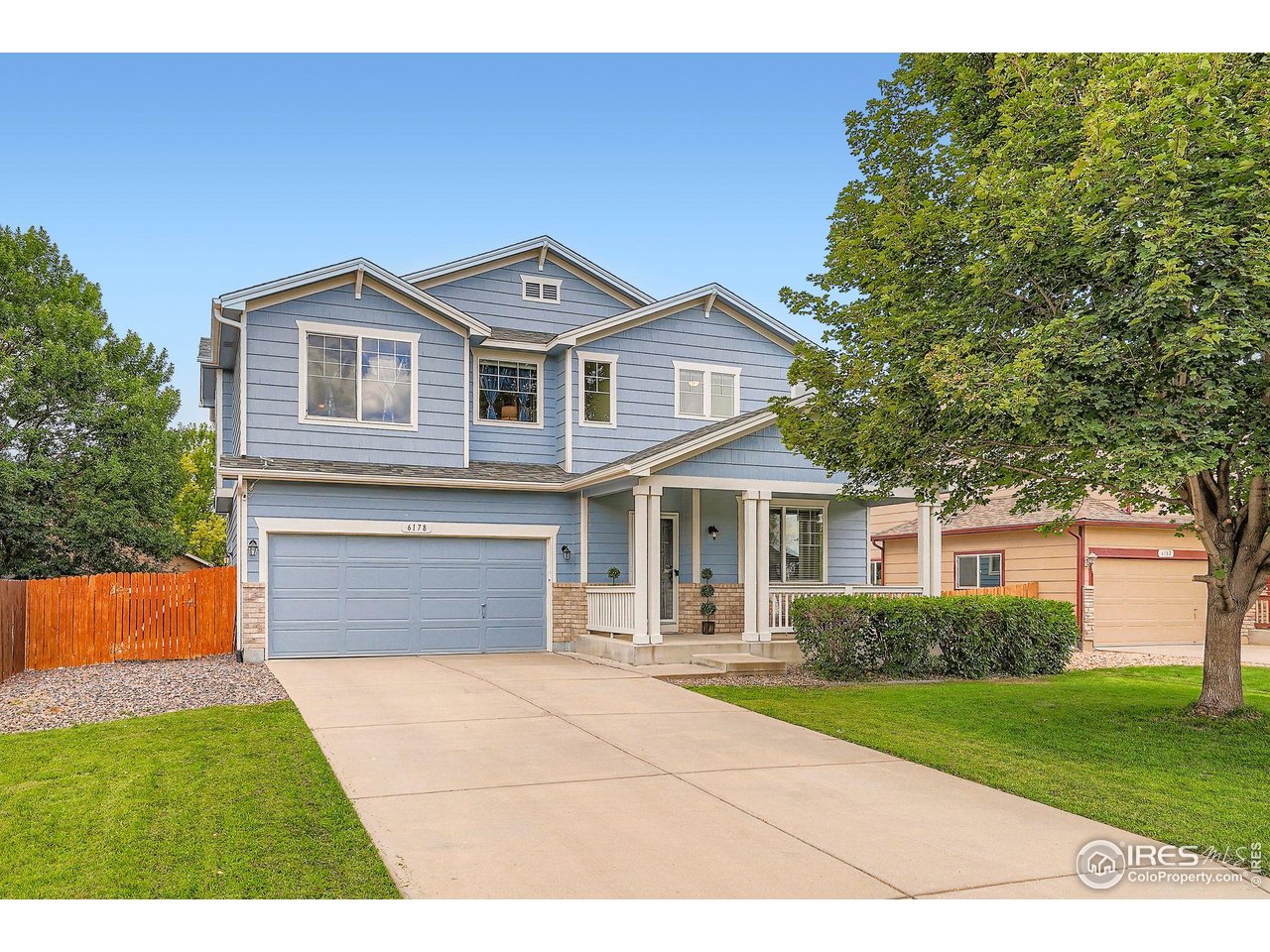 6178 Graden Street Frederick, CO 80530 - Photo 2 of 28 a front view of a house with a yard and garage