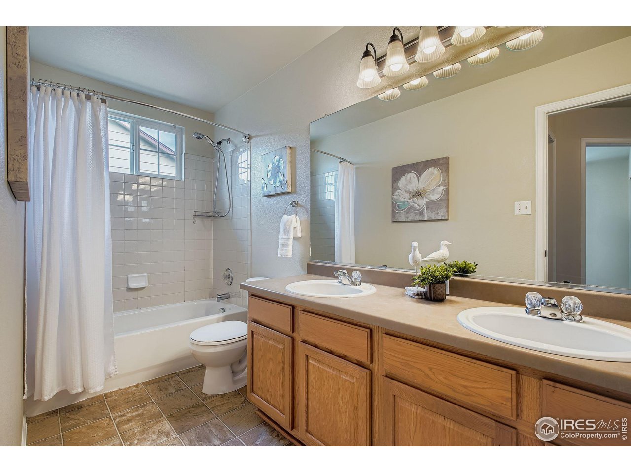 6178 Graden Street Frederick, CO 80530 - Photo 24 of 28 a bathroom with a granite countertop sink toilet mirror and bathtub