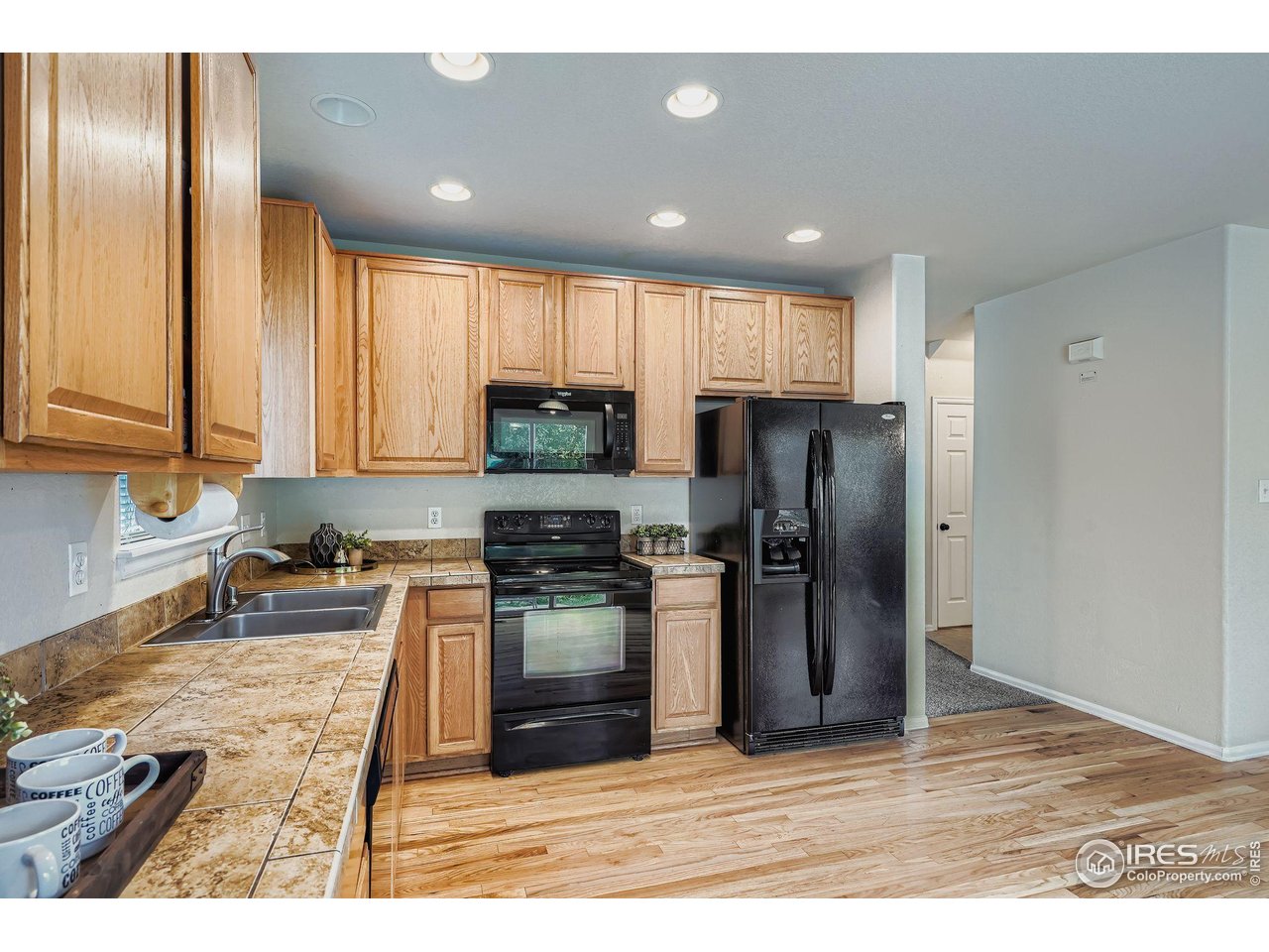 6178 Graden Street Frederick, CO 80530 - Photo 10 of 28 a kitchen with stainless steel appliances granite countertop a refrigerator and a stove top oven