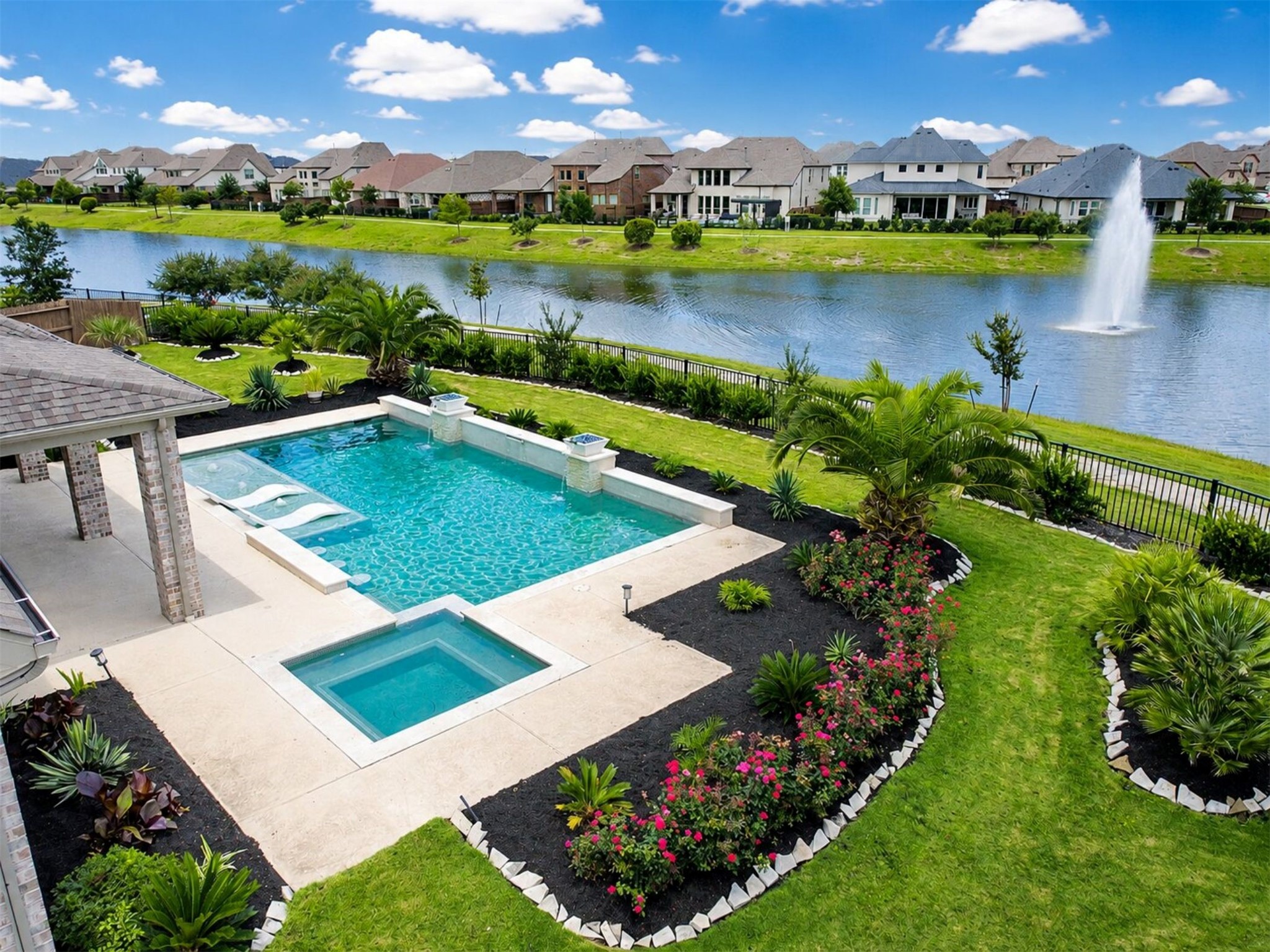 4343 Martin Ridge Drive Manvel, TX 77578 - Photo 2 of 50 a view of a swimming pool with a patio and a garden