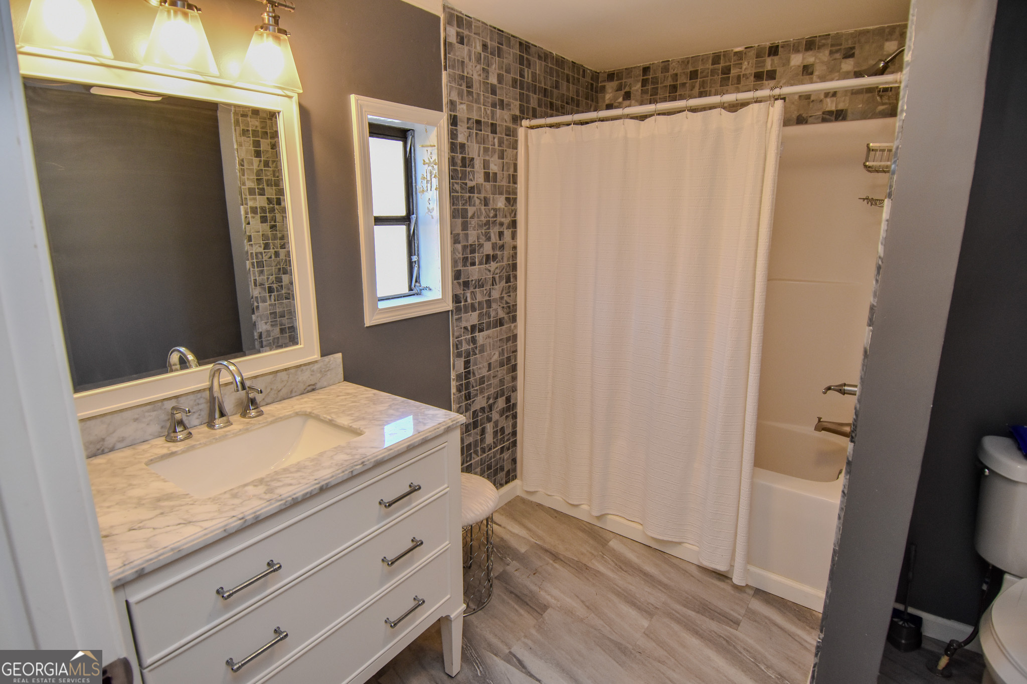 1256 Vaughn Road Griffin, GA 30223 - Photo 21 of 73 a bathroom with a granite countertop sink and a mirror