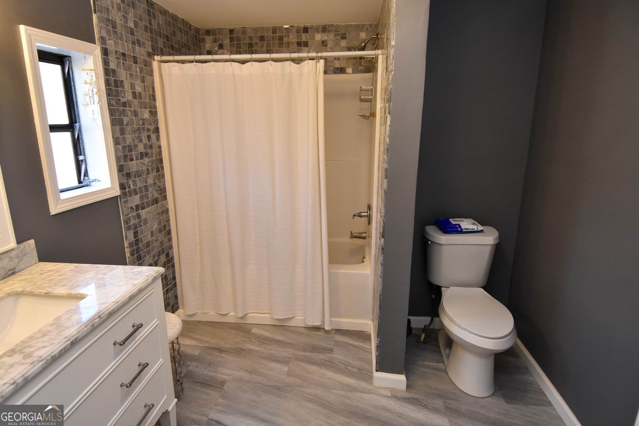 1256 Vaughn Road Griffin, GA 30223 - Photo 22 of 73 a bathroom with a toilet a sink and a shower