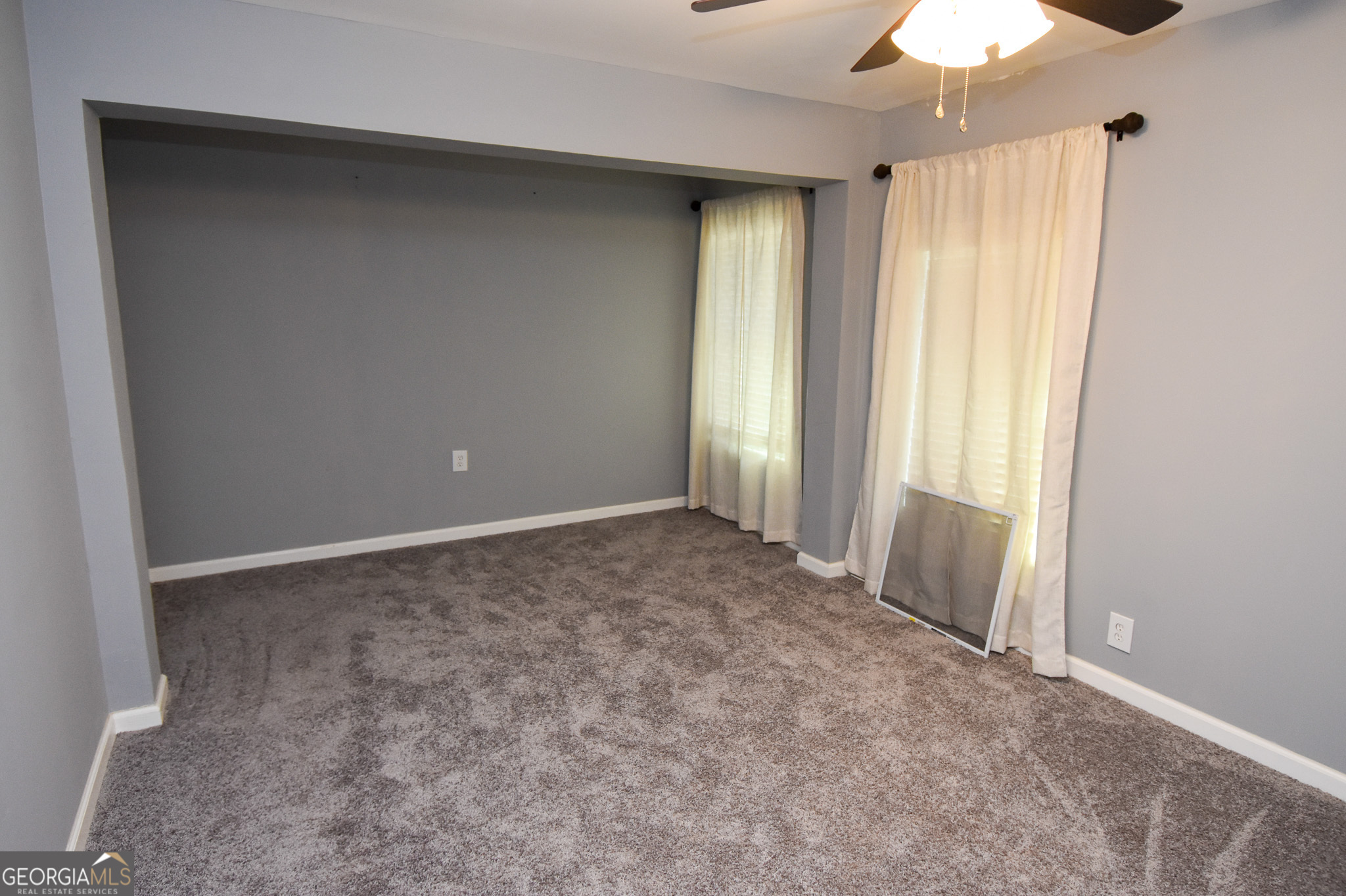 1256 Vaughn Road Griffin, GA 30223 - Photo 24 of 73 an empty room with windows and a chandelier fan