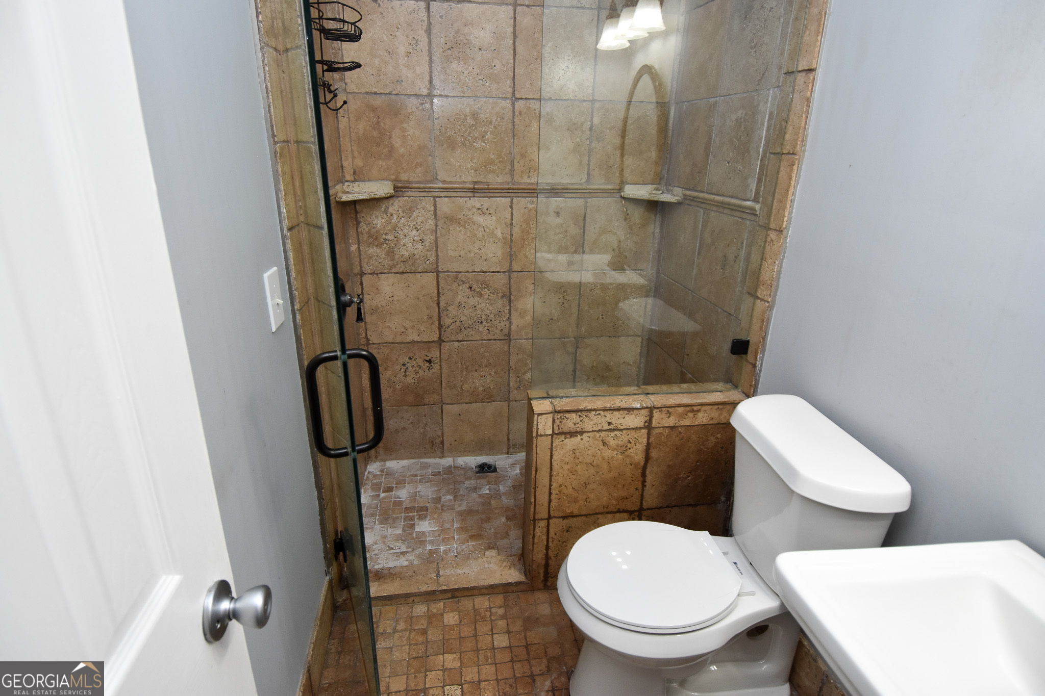 1256 Vaughn Road Griffin, GA 30223 - Photo 26 of 73 a white toilet sitting next to a bathroom sink