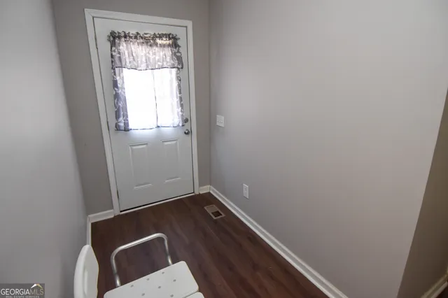 a view of a dining room with furniture and windows