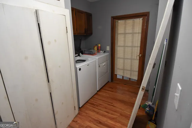 a front view of a house with a yard and large trees