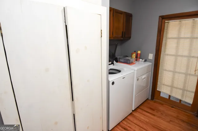 a view of a balcony with a floor to ceiling window and tree