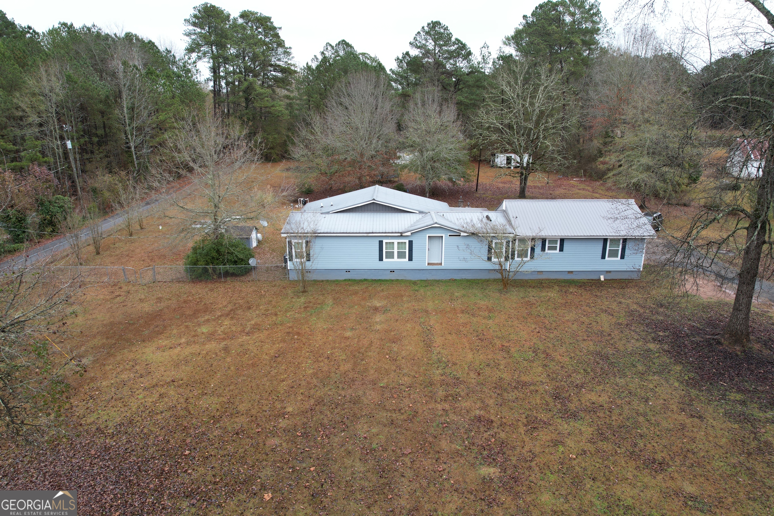 1256 Vaughn Road Griffin, GA 30223 - Photo 56 of 73 a front view of a house with a yard and large trees