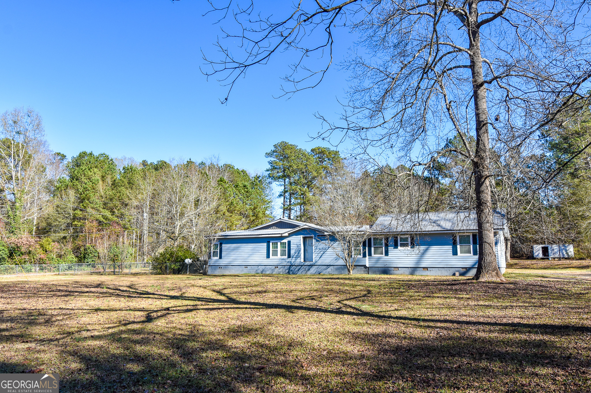 1256 Vaughn Road Griffin, GA 30223 - Photo 68 of 73 a view of a house with a yard covered with snow